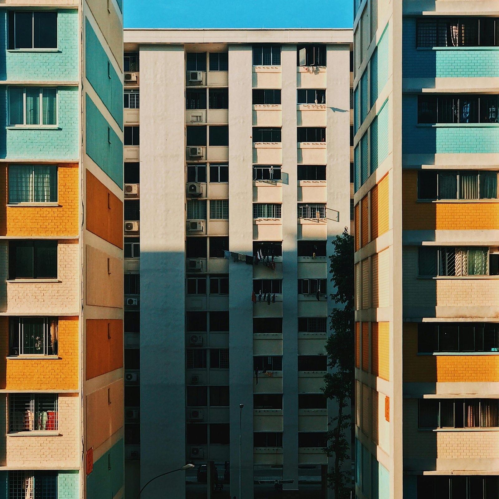 Vibrant facade of urban residential buildings in Singapore, capturing a geometric pattern.